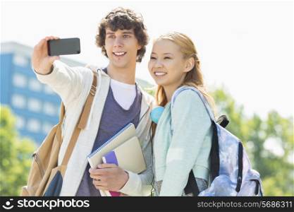 University friends taking selfie with smart phone at campus