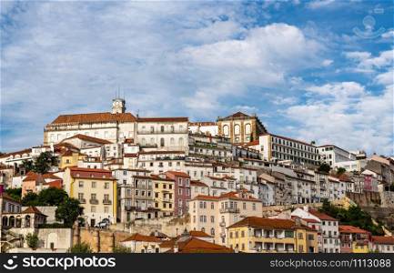 University of Coimbra on hilltop above the city from Santa Clara bridge. View from Santa Clara bridge towards the cityscape of Coimbra University