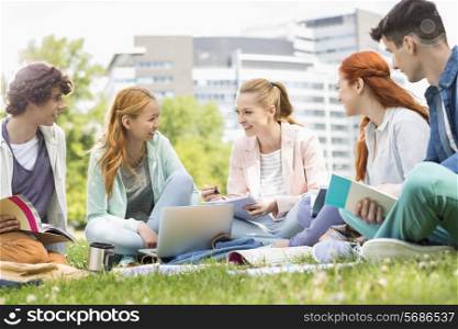 University students studying together on grass