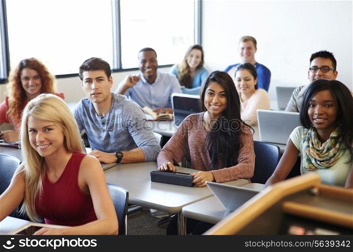 University Students Using Digital Tablet And Laptop In Class