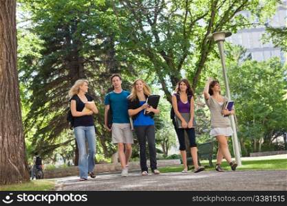 University students walking through the park on their way to college