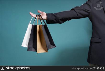 Unknown businessman hold the shopping paper bag , bargain sale concept .