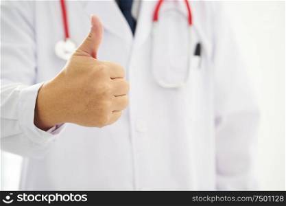 Unknown doctor hands with thumbs up .