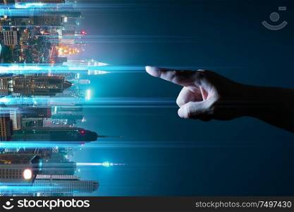 Unknown hand touching the light came out from the ground ,flip modern city background with wireless network connection concept , abstract communication technology image visual .