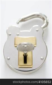 unlocked padlock with key on white background
