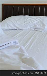 Unmade white bed