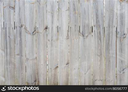 Unpainted gray wooden door consisting of old weathered unpainted boards