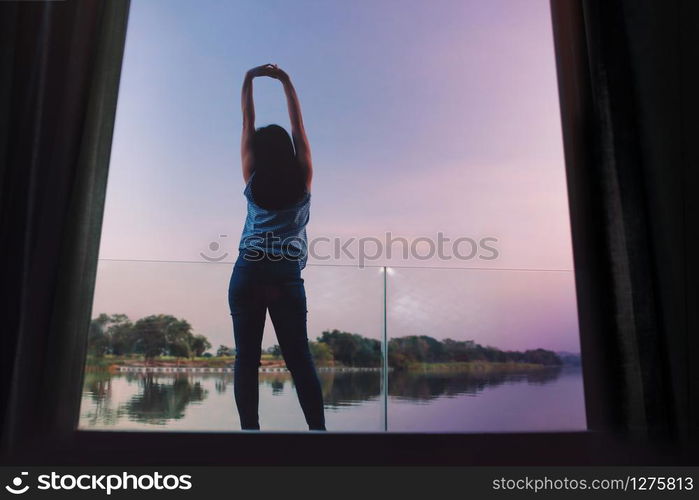 Unplugged Life Concept. Woman Relaxing by Nature in Countryside, Young Female Exercise on the Deck in the Morning by Riverside