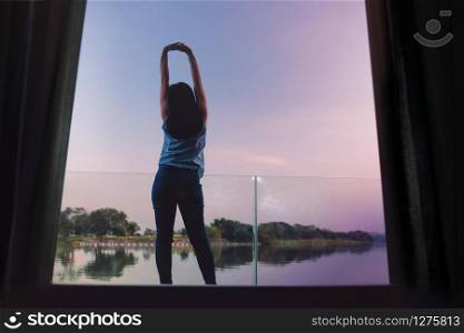 Unplugged Life Concept. Woman Relaxing by Nature in Countryside, Young Female Exercise on the Deck in the Morning by Riverside