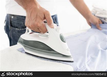 unrecognisable man ironing clothes. Beautiful photo. unrecognisable man ironing clothes