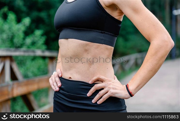 Unrecognizable athlete woman with sportswear posing outdoors