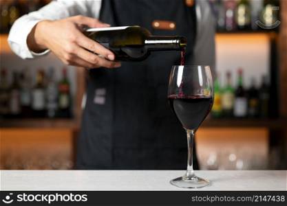Unrecognizable Bartender serving red wine. High quality photo. Unrecognizable Bartender serving red wine. High quality photography