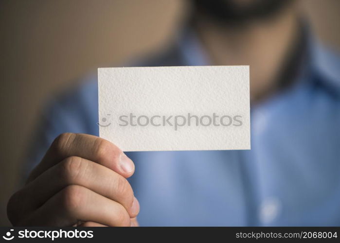 unrecognizable businessman with card