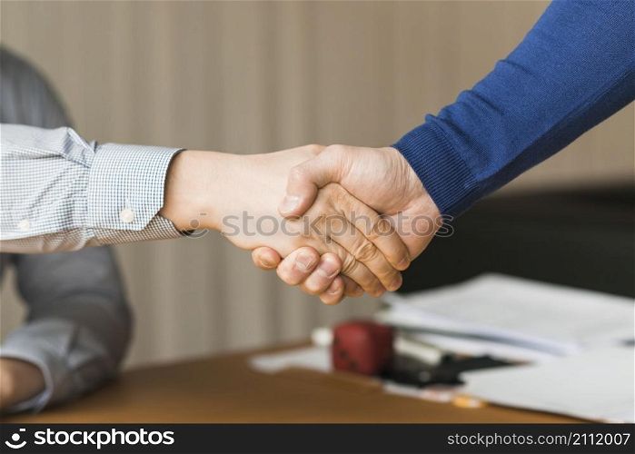 unrecognizable businessmen handshaking
