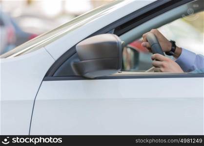 Unrecognizable man driving his car closeup
