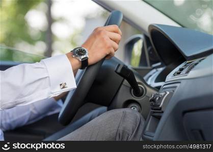 Unrecognizable man driving his car closeup