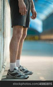 Unrecognizable man with athletic pair of legs going for jog or run during sunrise or sunset - healthy lifestyle concept
