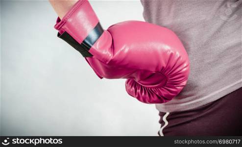 Unrecognizable sporty woman wearing red boxing gloves. Studio shot on dark background.. Woman wearing boxing gloves