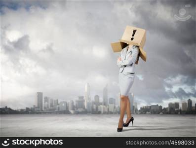 Unrecognizable woman. Businesswoman wearing carton box with marks on head