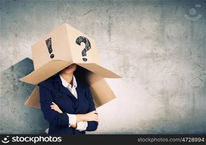 Unrecognizable woman. Businesswoman wearing carton box with marks on head