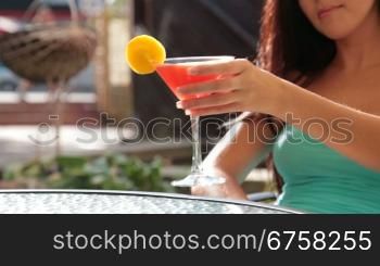 unrecognizable woman drinking cocktail in restaurant