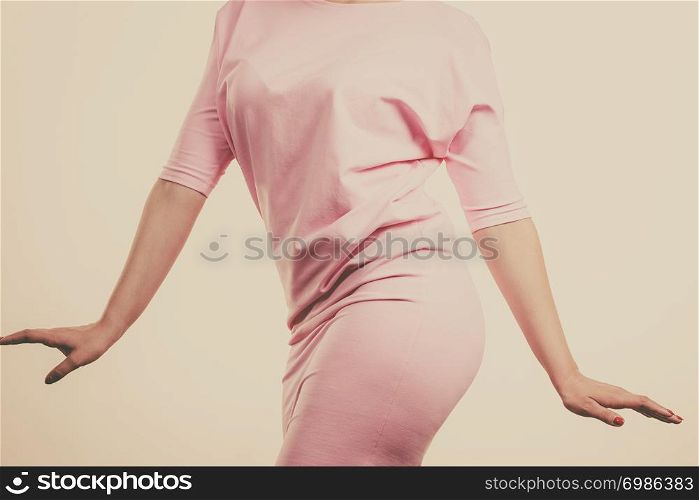 Unrecognizable woman having fashionable outfit, pastel skirt. Fashion and clothing concept. Gray background. Unrecognizable woman presenting outfit