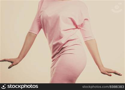 Unrecognizable woman having fashionable outfit, pastel skirt. Fashion and clothing concept. Gray background. Unrecognizable woman presenting outfit