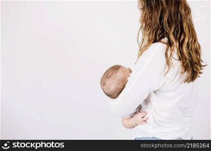 unrecognizable woman holding baby