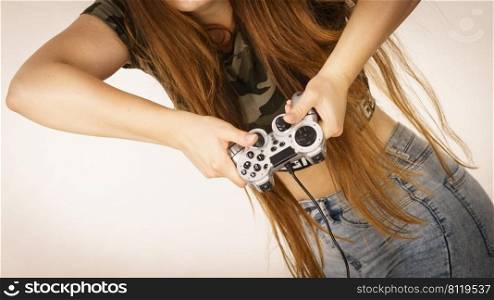 Unrecognizable woman playing on the video console holding game pad. Gaming gamers concept.. Gamer woman holding gaming pad