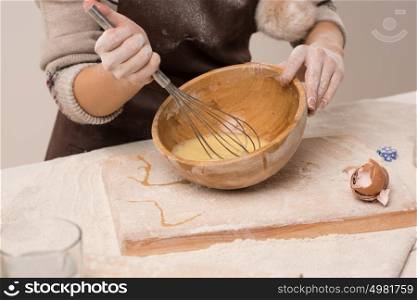 Unrecognizable woman preparing dough, closeup photo