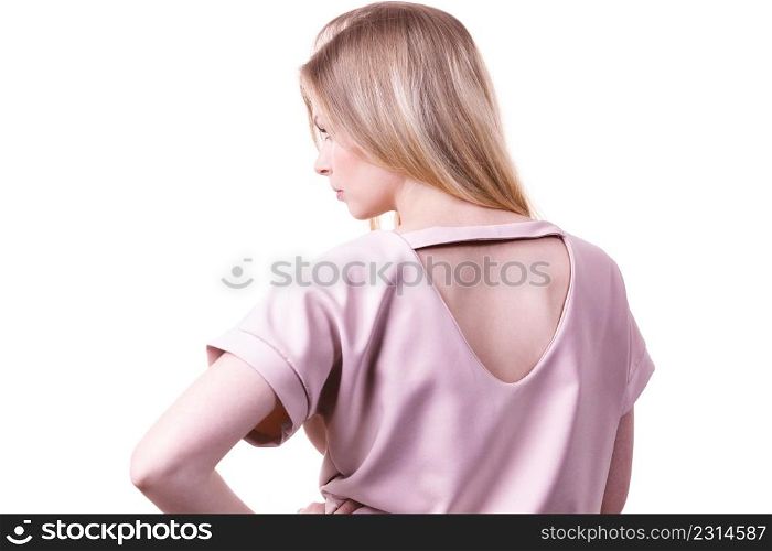 Unrecognizable woman presenting fashionable pink top with hole detail on her back.. Woman showing hole detail on back of top