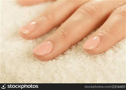 Unrecognizable woman presenting her beautiful painted pink gel hybrid nails. Nail care concept.. Woman presenting her beautiful painted gel hybrid nails