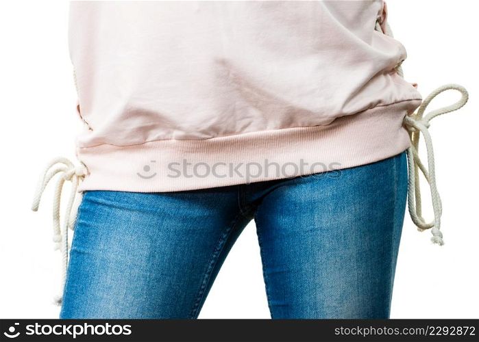 Unrecognizable woman presenting her casual beautiful outfit, short sleeved white top and jeans.. Woman wearing casual outfit
