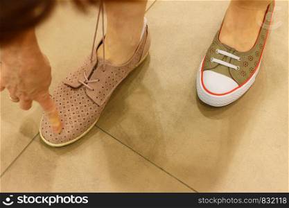 Unrecognizable woman trying on new shoes, getting comfortable in shop buying and choosing best footwear.. Unrecognizable woman trying on shoes