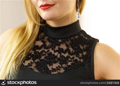 Unrecognizable woman wearing black top with laced detail on chest. Fashion, clothing style concept.. Woman wearing black top