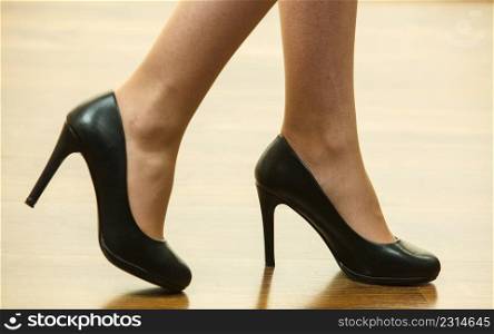 Unrecognizable woman wearing dress or skirt and black elegant fashionable high heels.. Unrecognizable woman wearing high heels