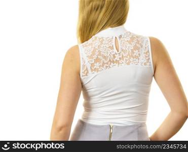 Unrecognizable woman wearing white top with laced detail on back. Fashion, clothing style concept.. Woman wearing white top