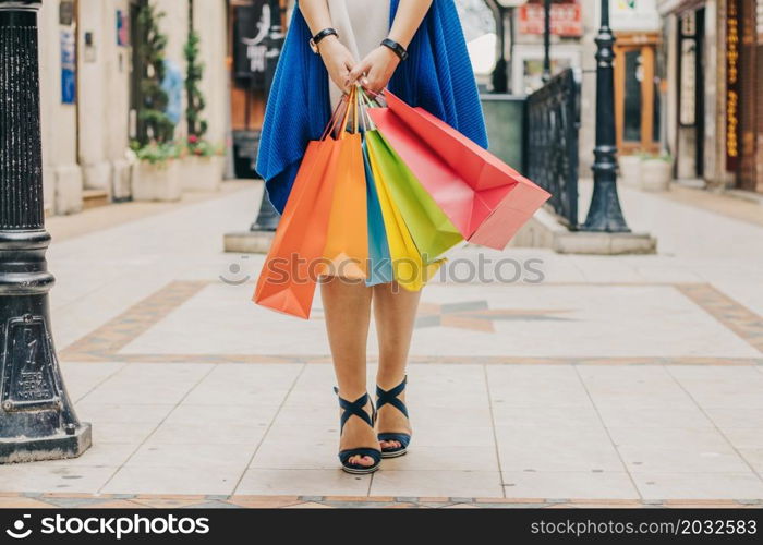 unrecognizable woman with shopping bags