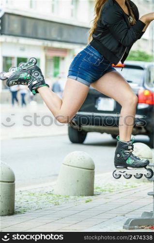 Unreocgnizable crazy woman wearing roller skates riding in town. Female being sporty having fun during summer time.. Unrecognizable woman riding roller skates