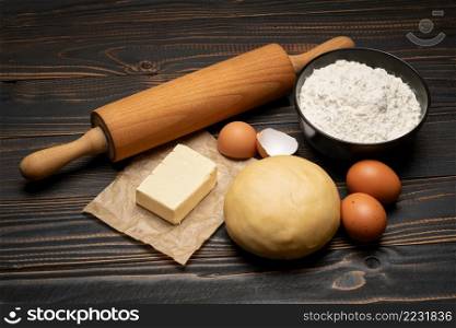 unrolled and unbaked Shortcrust pastry dough recipe on wooden background or table. unrolled and unbaked Shortcrust pastry dough recipe on wooden background