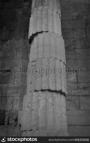 Unstable ancient greek column. Marble pillar unbalanced structure black and white.