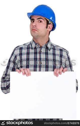 Unsure construction worker holding up a blank sign