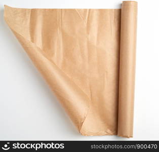 untwisted bundle of brown parchment baking paper on a white background, top view