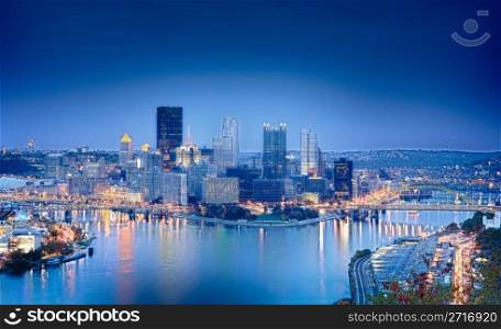 Unusual blue shaded image of Pittsburgh in the evening processed in HDR to highlight the reflections in the river