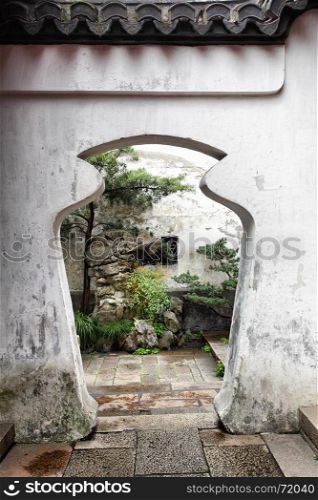 Unusual doorway in ancient Yu Yuan Garden in Shanghai, China