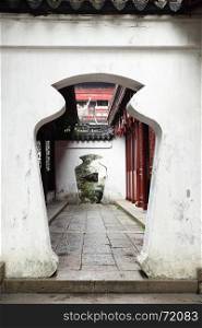 Unusual doorway in ancient Yu Yuan Garden in Shanghai, China