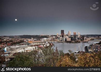 Unusual paint like view of the city of Pittsburgh at sunset as the moon rises over the horizon