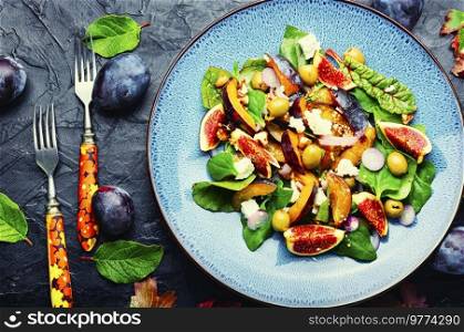 Unusual salad with figs, plums, herbs and olives.. Vitamin salad with fruit, olives and herbs