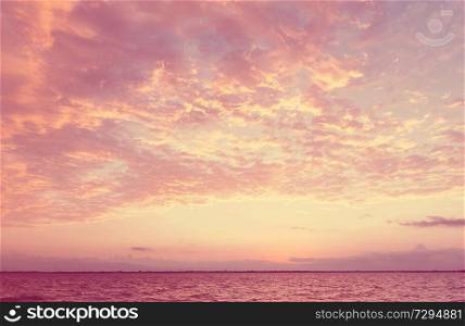 Unusual storm clouds at sunset. Bright living coral colors of the sky. Suitable for background.