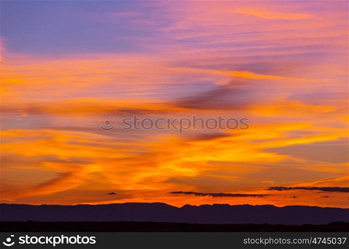 Unusual storm clouds at sunset. Bright red and orange colors of the sky. Suitable for background.